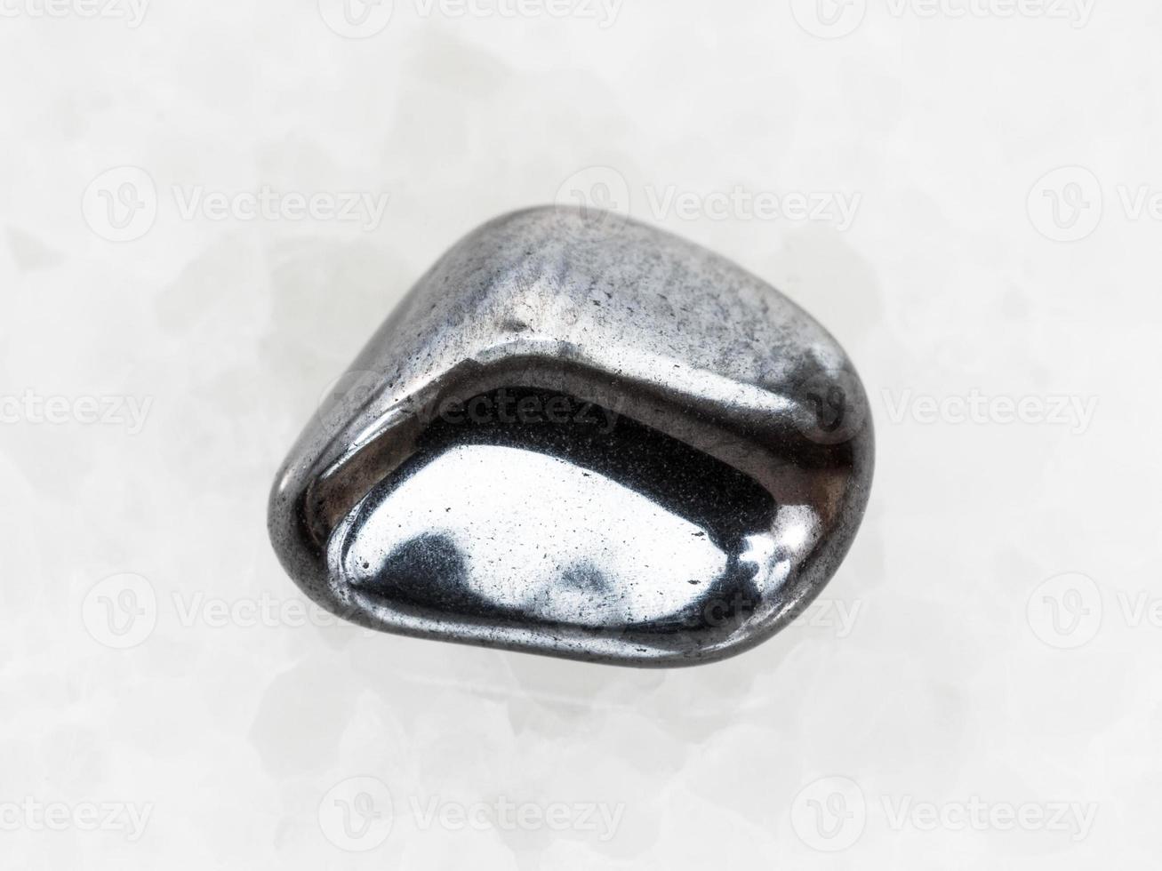 tumbled hematite gem on white marble photo