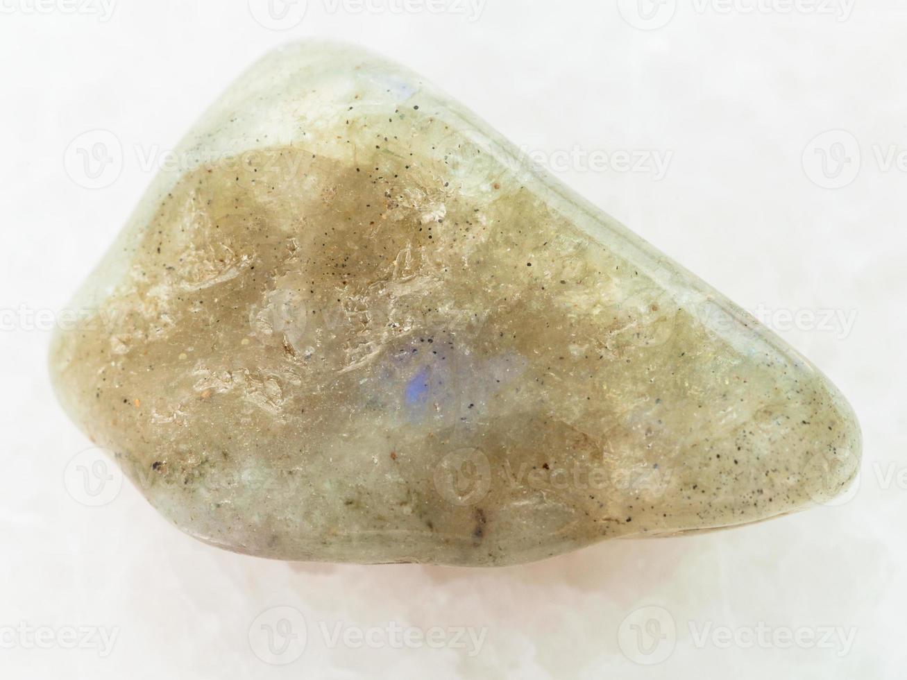 tumbled labradorite gemstone on white marble photo
