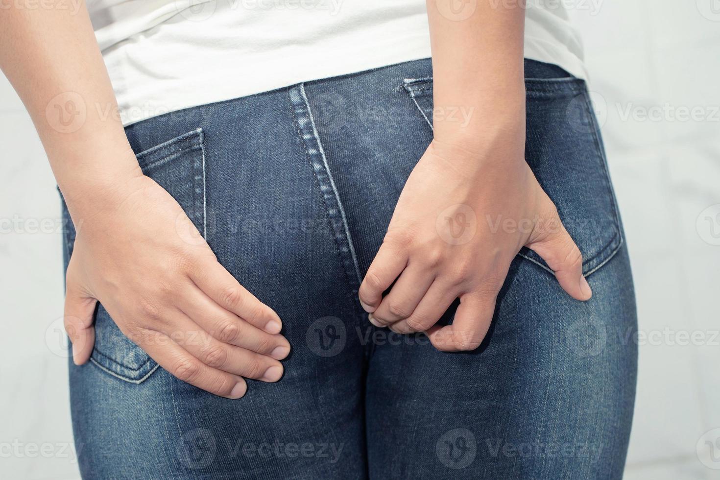 The woman was suffering from hemorrhoids and put her hand on her buttocks because of abdominal pain Health care concept. photo