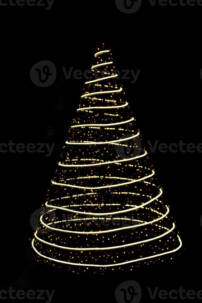 Defocused lights Christmas tree on black isolated background. Design element. New Year. Copy space photo