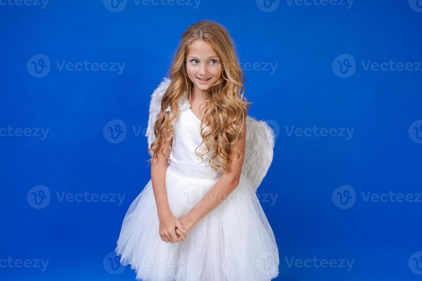 Postcard for valentine's day. Child in long white dress and with angel wings photo