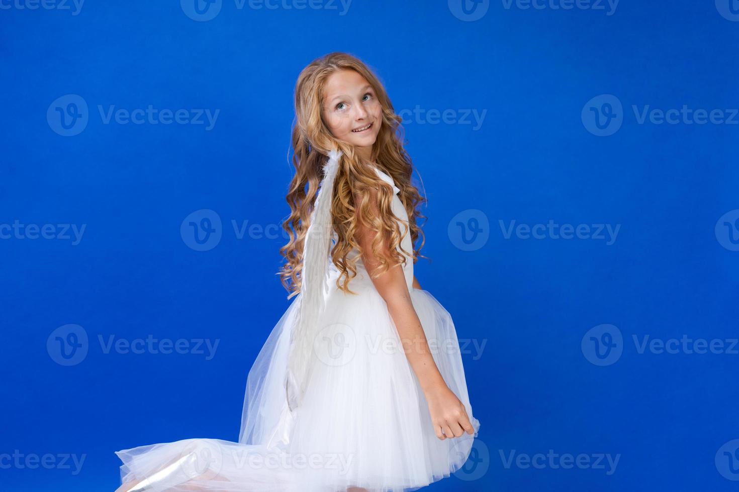 God of love. Valentine daygirl concept dressed as an angel on a blue background. photo