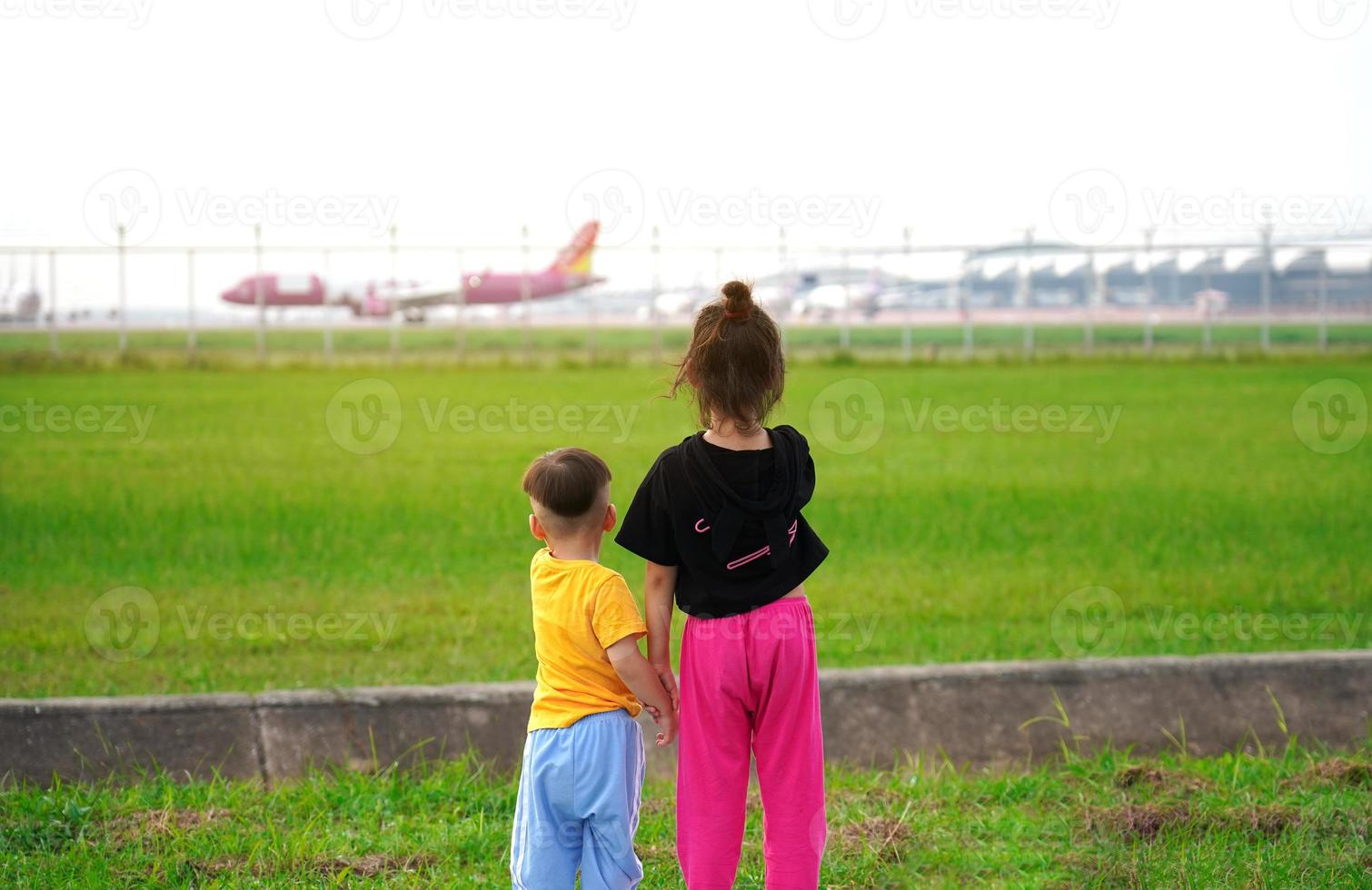 The children were excited and happy to see the planes take off and land beside the airport. photo