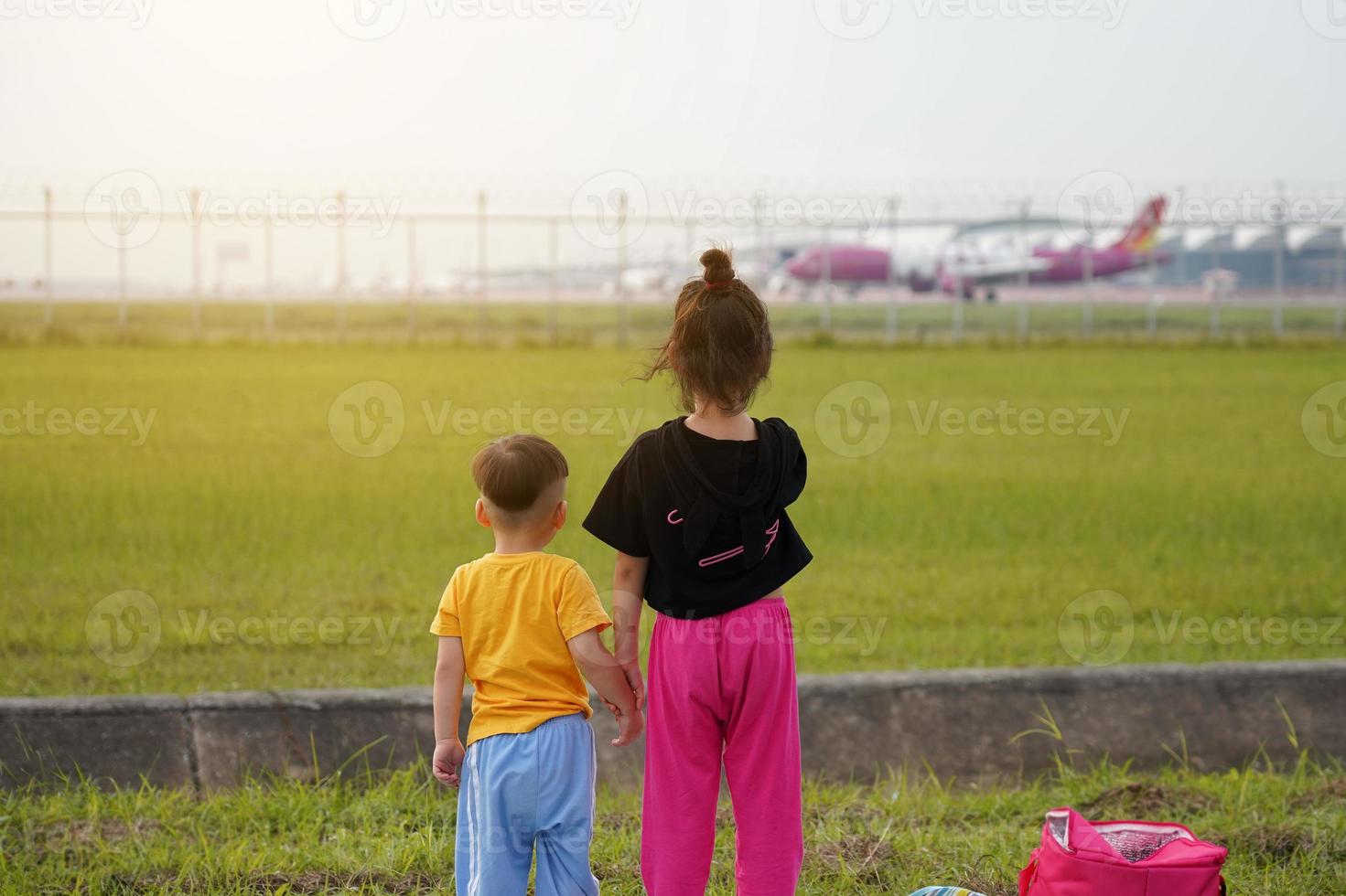 The children were excited and happy to see the planes take off and land beside the airport. photo