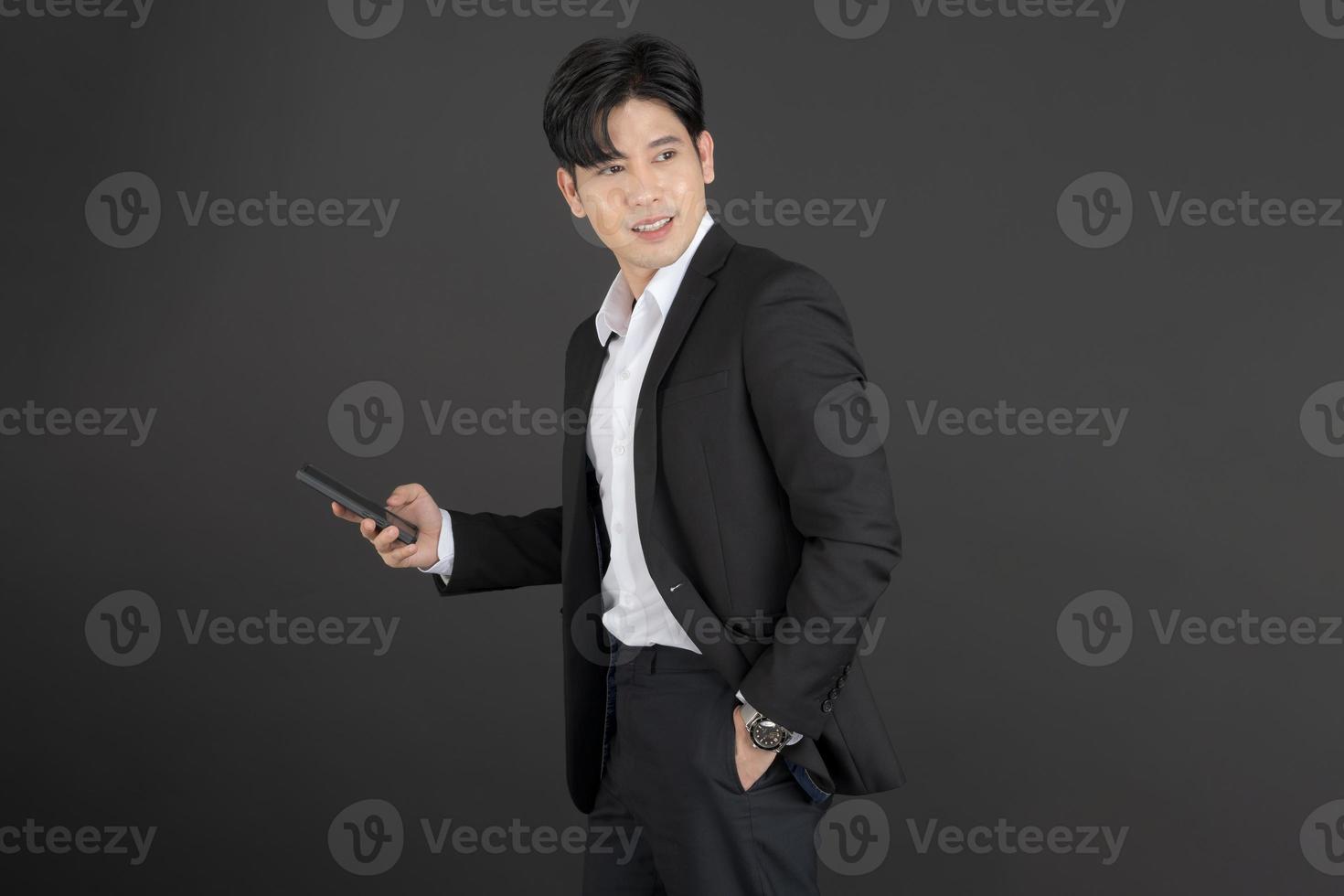 Business man wearing white shirt holding mobile phone photo