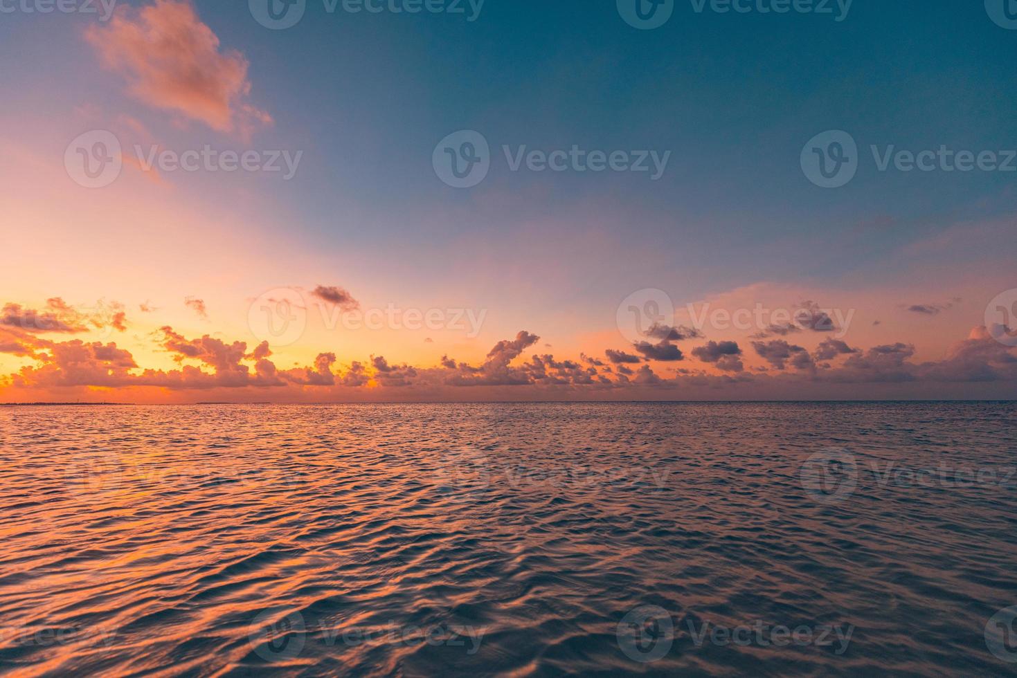 Calm sea with sunset sky and sun through the clouds over meditation ocean and sky background. Tranquil seascape. Horizon over the water, peaceful relaxation nature. Ocean lagoon, horizon seaside photo