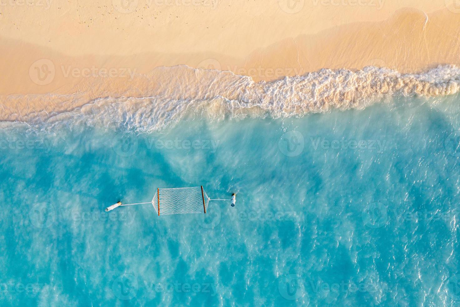 Relaxing aerial beach scene, summer vacation holiday template banner. Waves surf with amazing blue ocean lagoon, sea shore, coastline. Perfect aerial drone top view. Peaceful bright beach, seaside photo