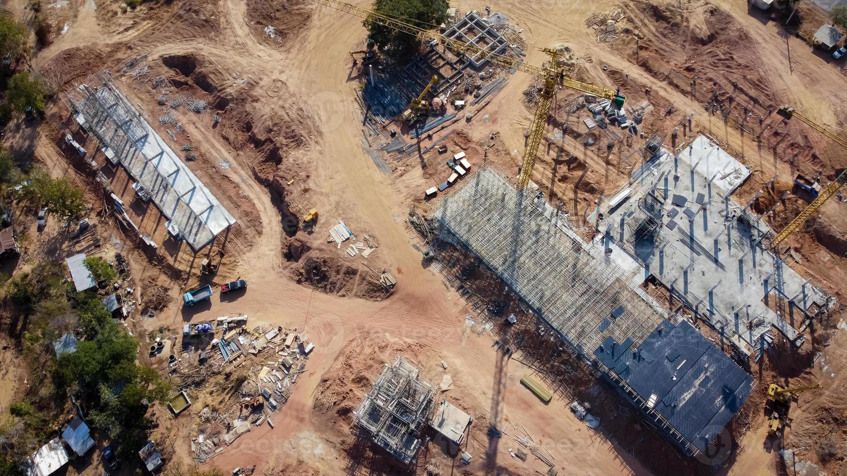 vista aerea el proyecto es la construccion de un gran edificio. grúa de construcción amarilla y trabajadores están trabajando, fotos de drones