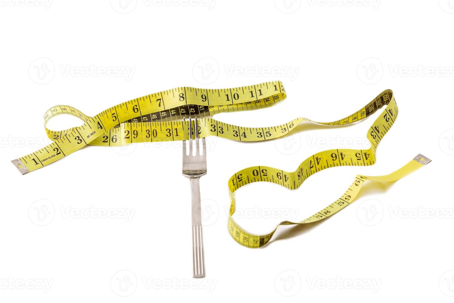 Fork and centimeter tape on a white background, slimming concept photo