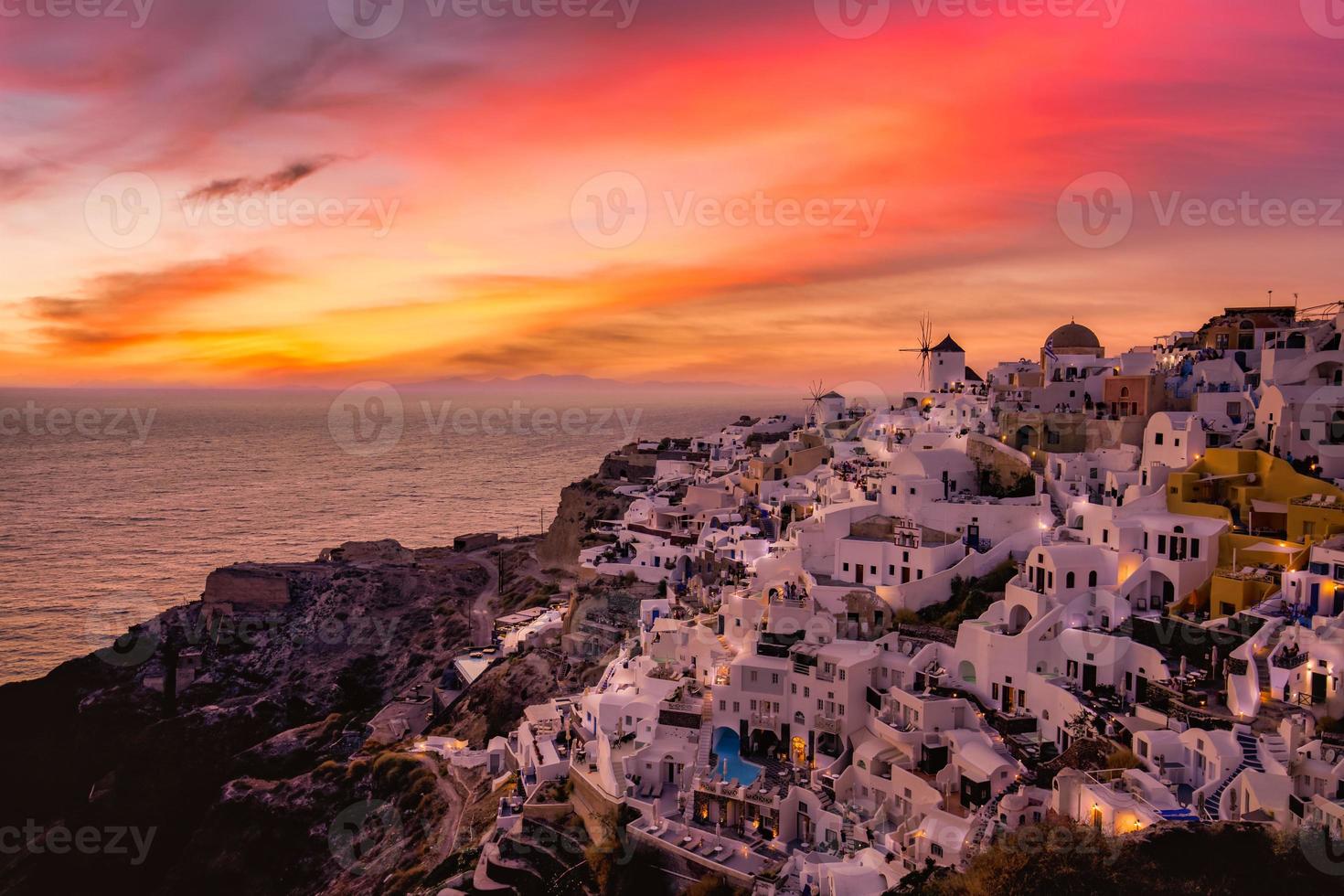 Sunset night view of traditional Greek village Oia on Santorini island in Greece. Santorini is iconic travel destination in Greece, famous sunset point landscape and traditional white architecture photo