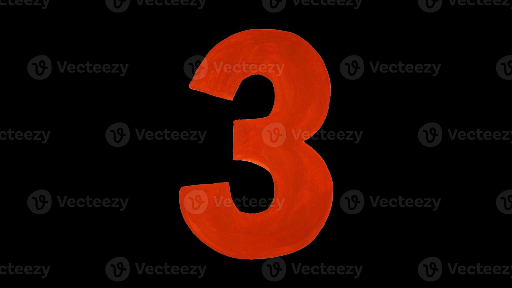 Red number three drawn gouache. Isolated on a black background. Figure hand drawn by paint photo