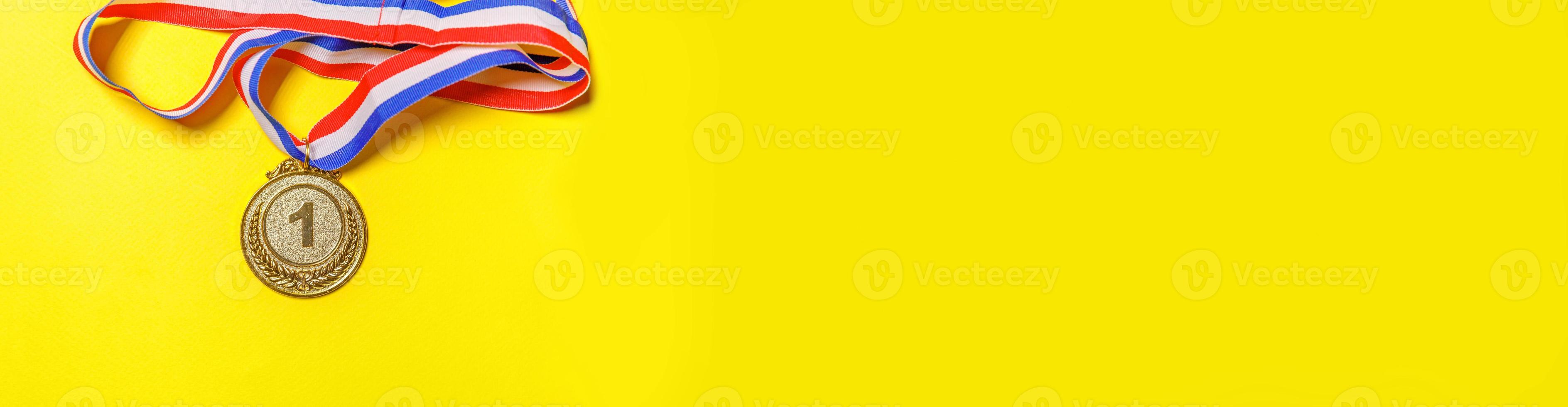 Simply flat lay design winner or champion gold trophy medal isolated on yellow colorful background. Victory first place of competition. Winning or success concept. Top view copy space banner. photo