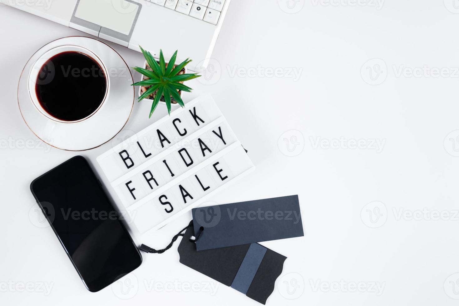 Black Friday concept. Laptop and coffee cup on white background. Online sale photo