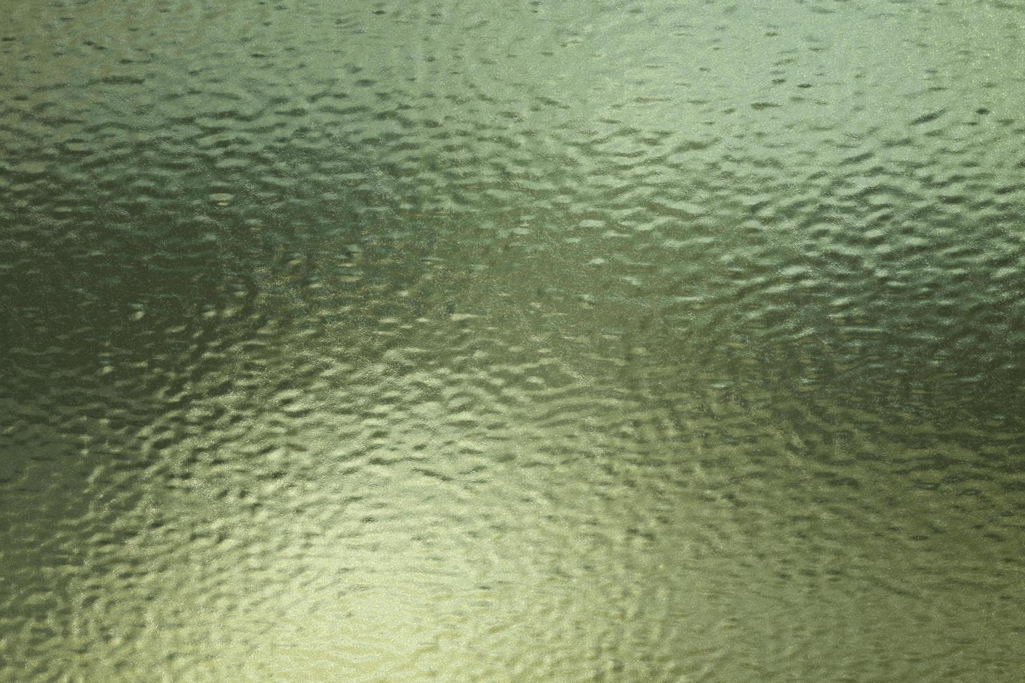 Texture of green frosted glass sheet with scratches, abstract texture background photo