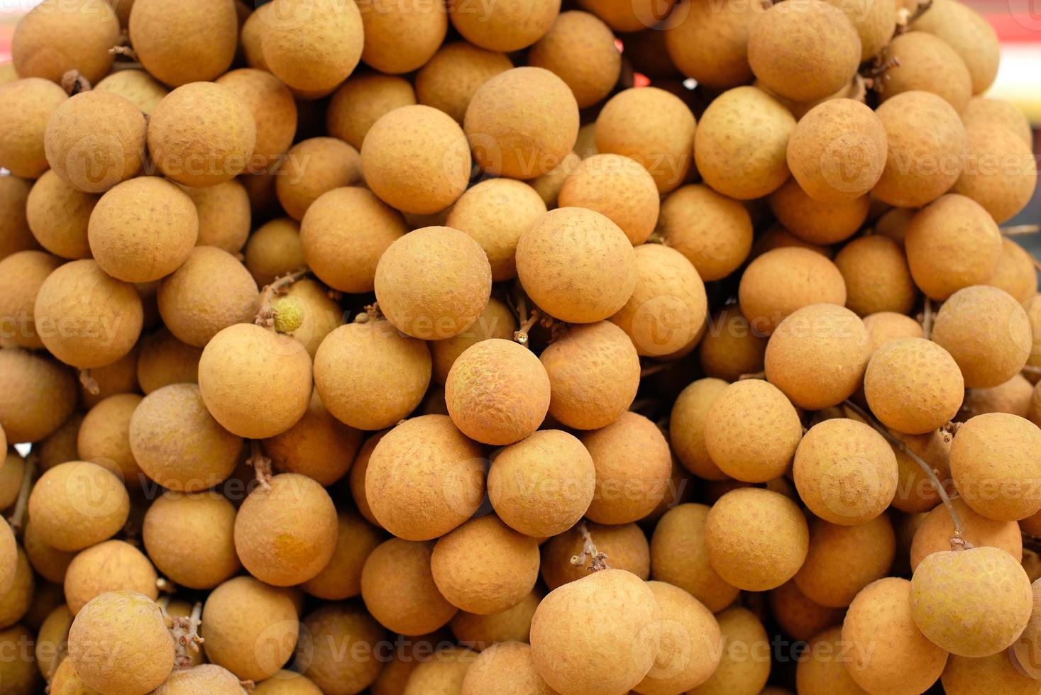 Fresh longan fruit on the market. close up details of longan fruit or kelengkeng fruit. photo
