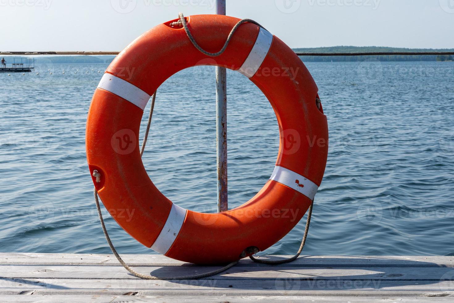 Lifebuoy hanging on the handle of the pier. The concept of saving drowning photo