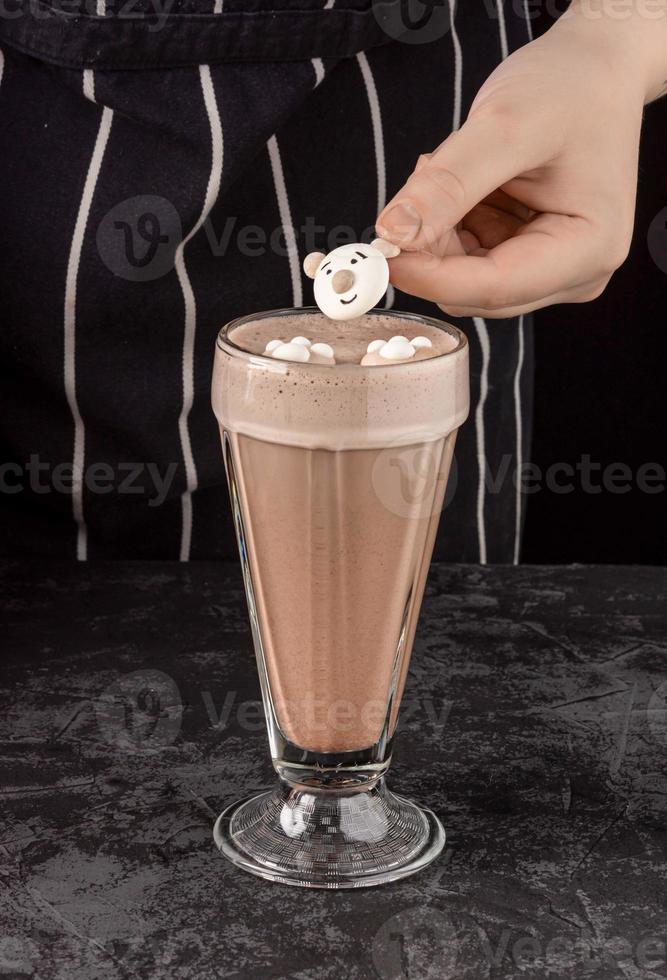 cocoa drink decorated with funny cookies on a dark background photo