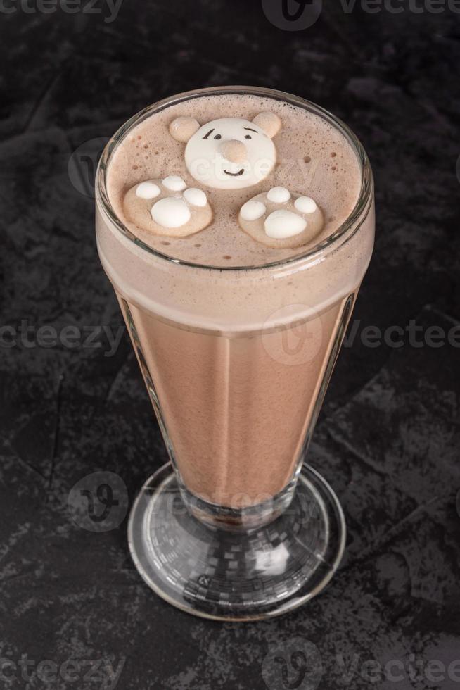 cocoa drink decorated with funny cookies on a dark background photo