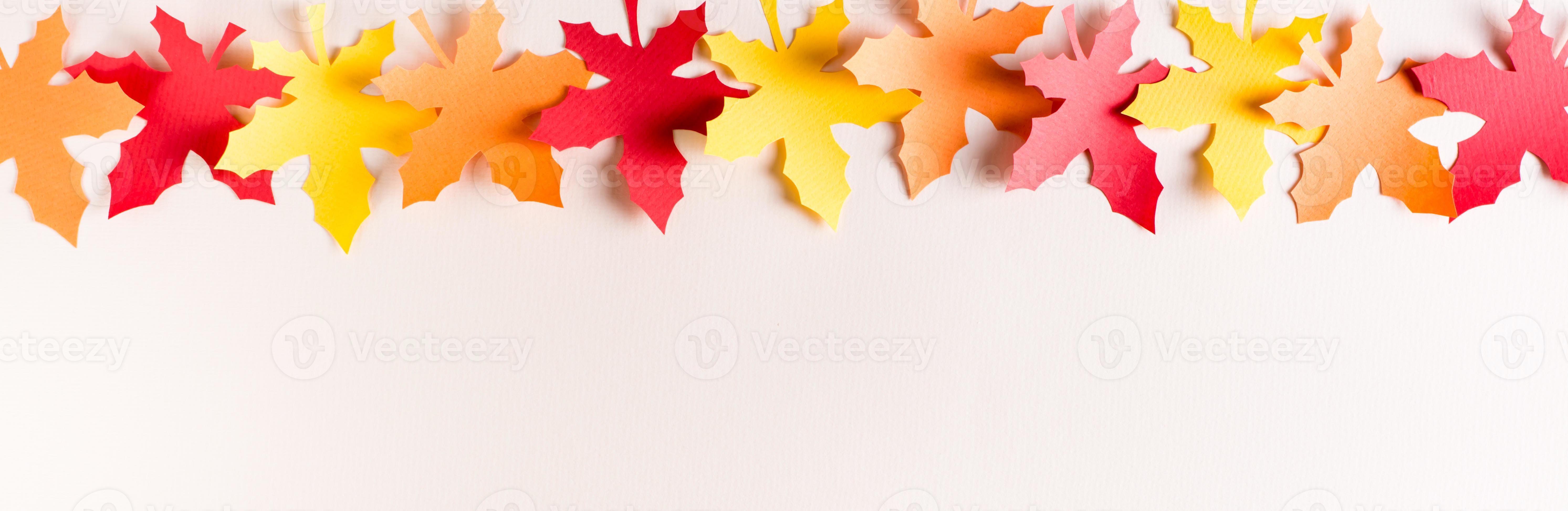 Row of cut out maple colorful leaves made from craft paper. Autumn