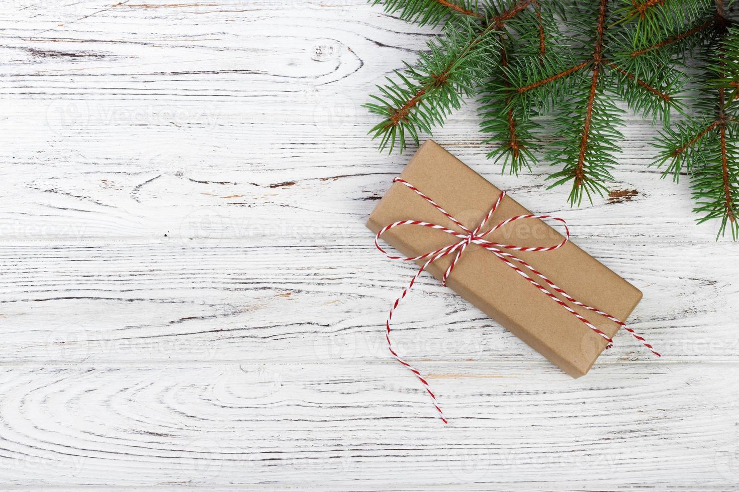 Christmas background with fir tree, gift box and decor. Top view with copy space photo