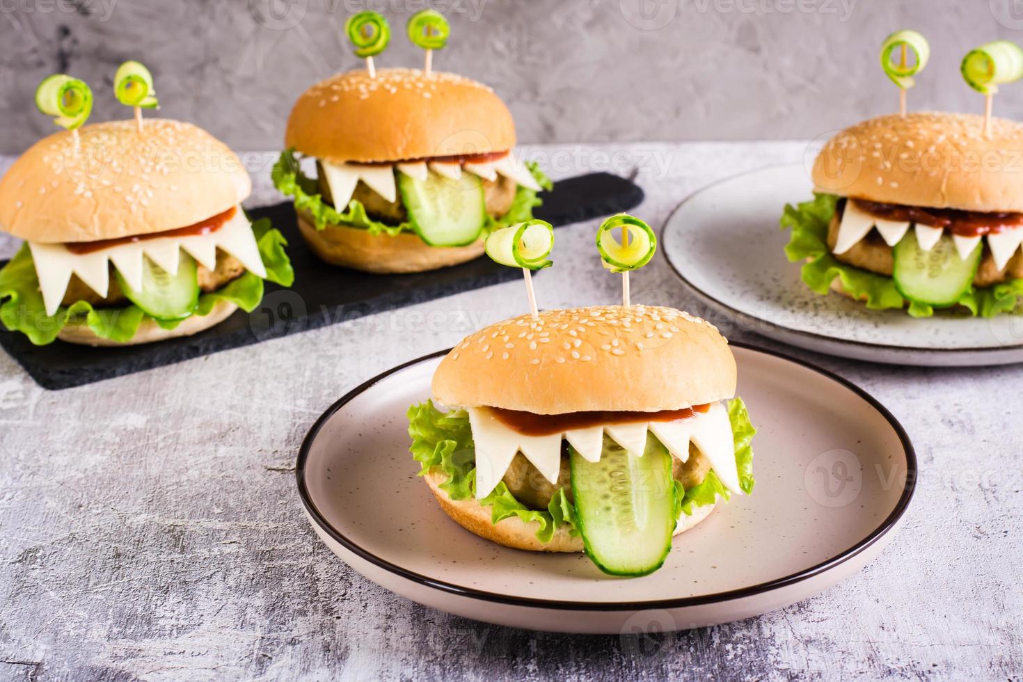 Homemade monster burgers with eyes and tongue for halloween menu on the table photo