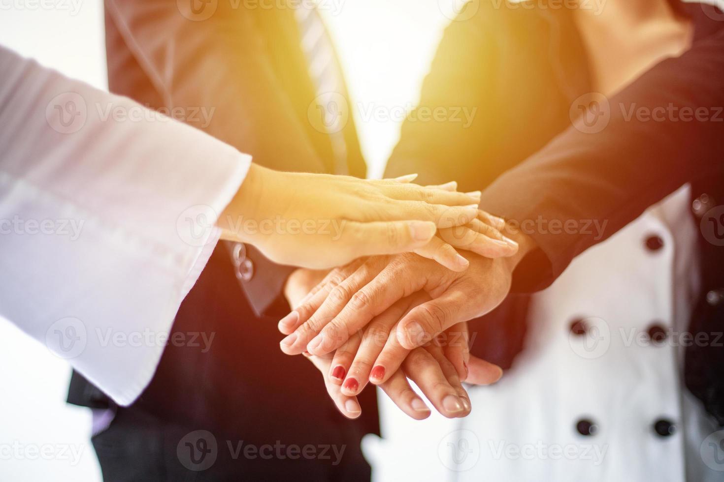 Group Asian Young businessmen join hands for working the job success, Hand coordination, symbolizing the hands to unity and teamwork photo