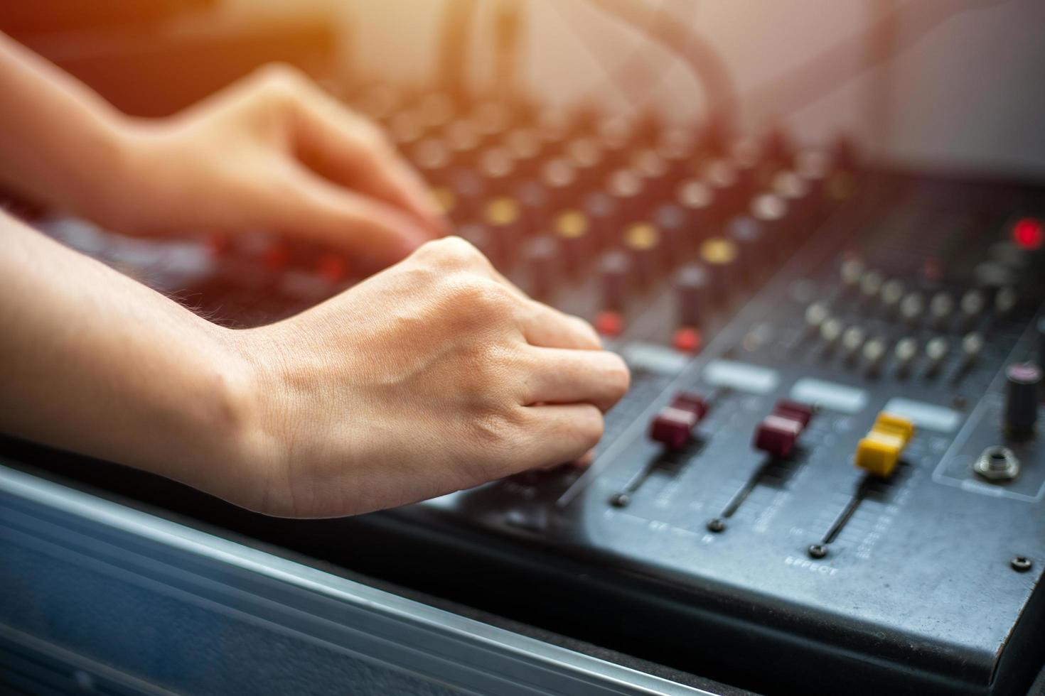 close up hands tuning of sound mixer photo