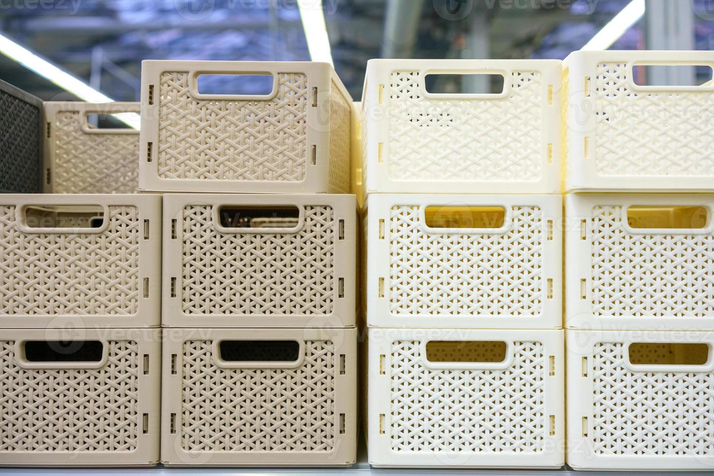 Plastic baskets on the shelf in the store photo