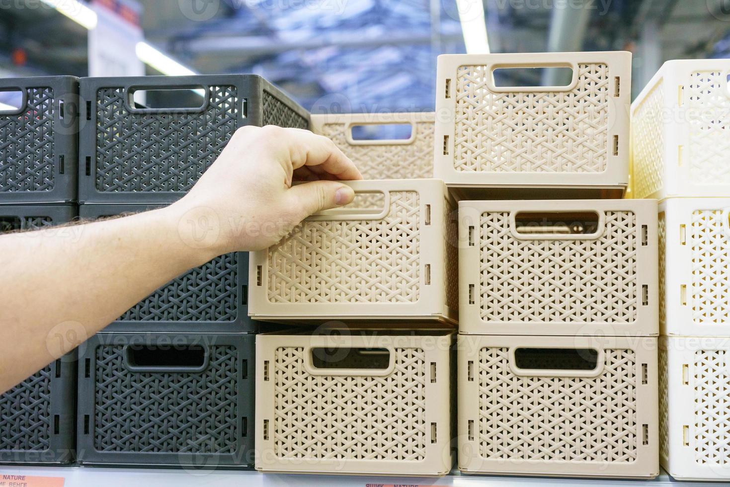 Plastic baskets on the shelf in the store photo