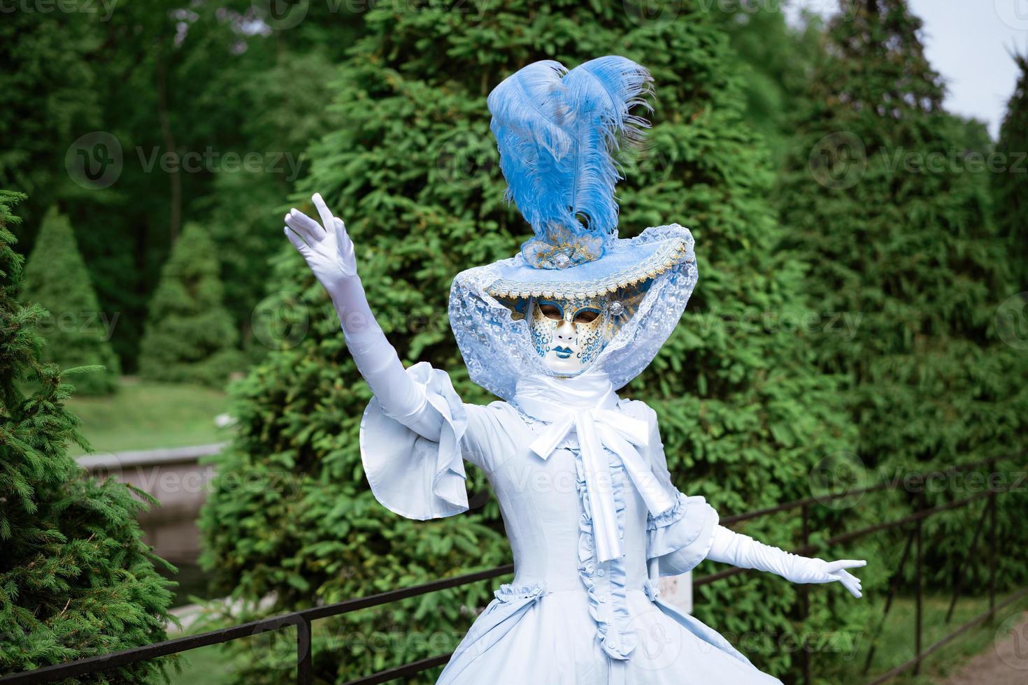 Woman in carnival dress mask photo