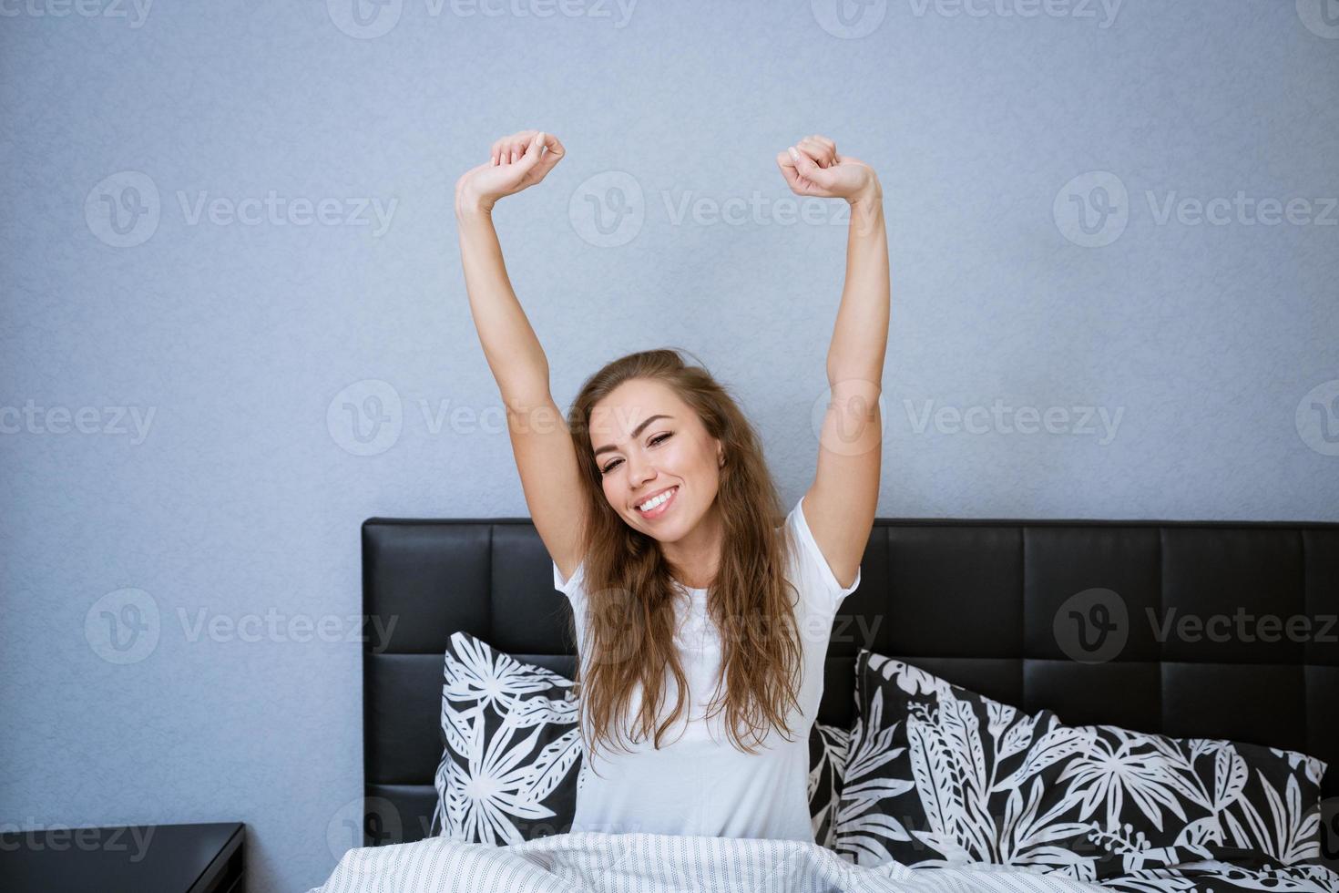 Beautiful caucasian woman at home in bed relaxing photo
