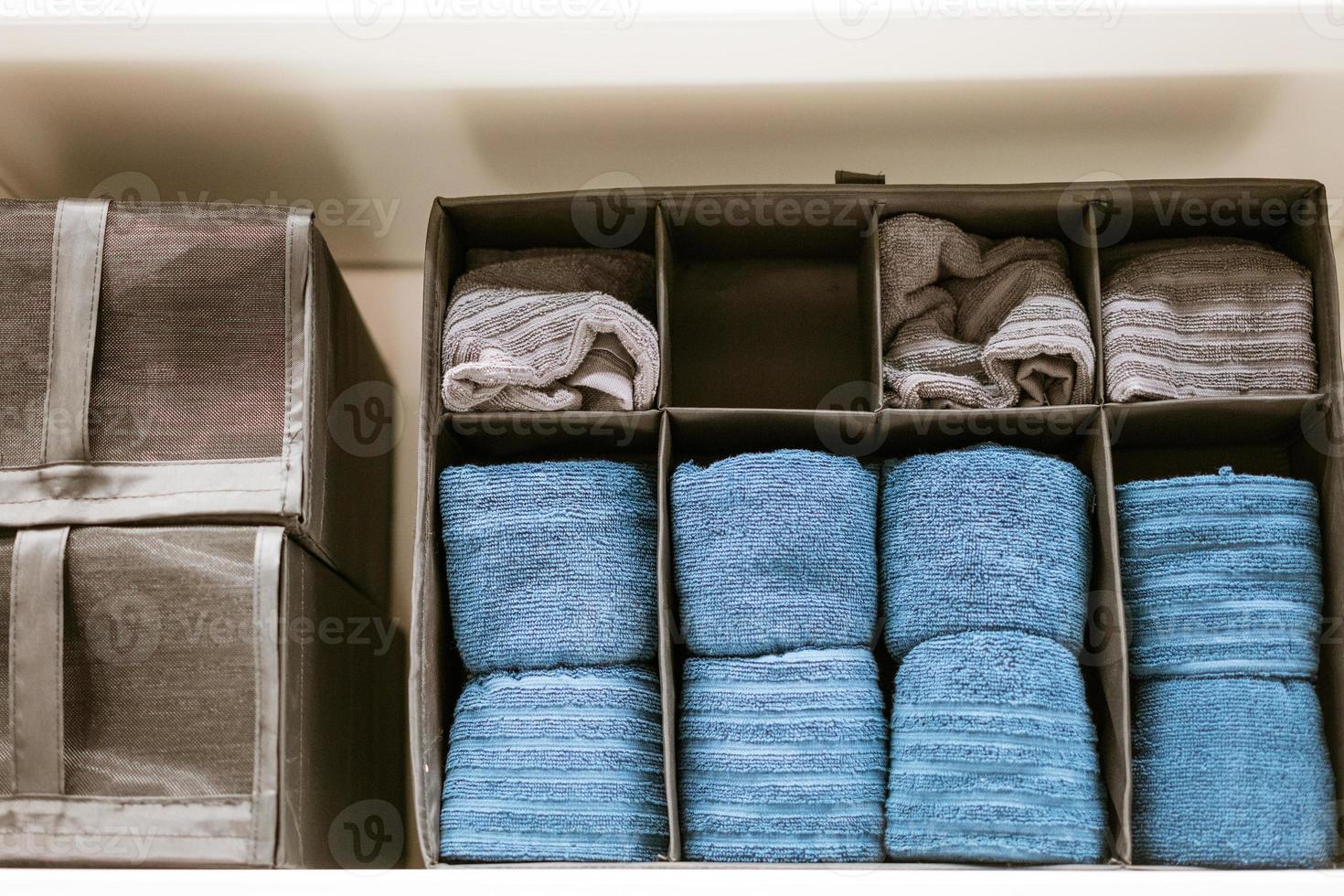 there are clean towels on the shelf in the closet photo