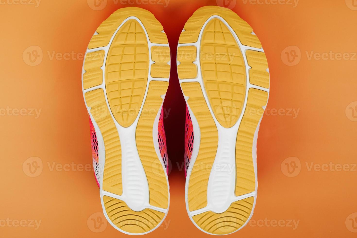 Yellow sole of a sneaker on a yellow background. photo