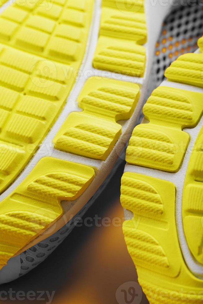 Textured design of the sole of the Tread of a sneaker in yellow Macro. photo