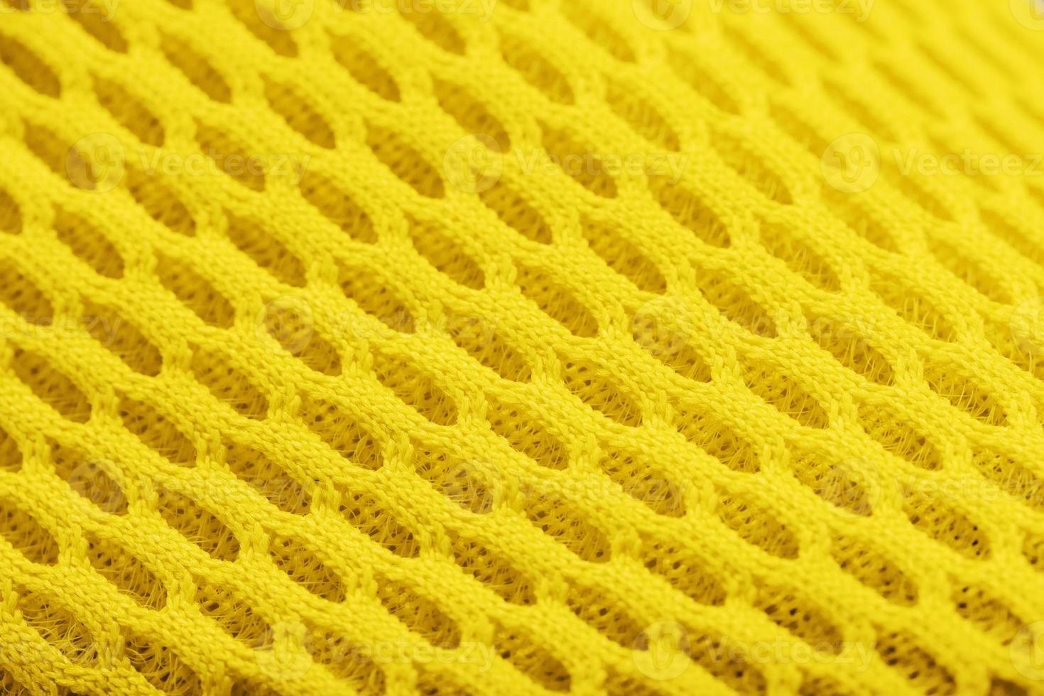 Fragment of a perforated toe of a yellow sneaker in close-up. photo
