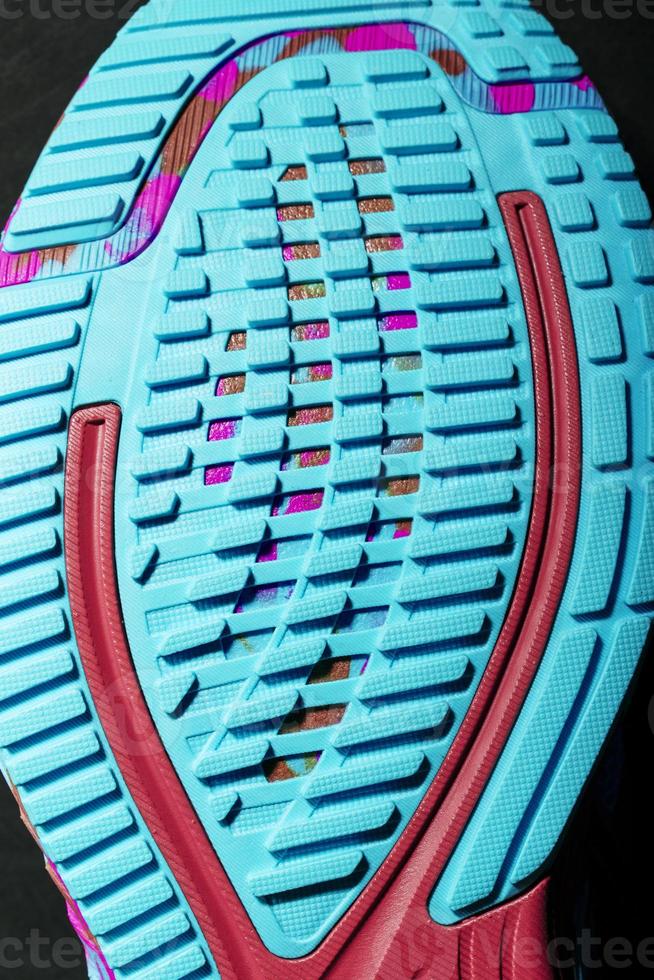 Turquoise outsole tread with sports sneakers for jogging and fitness. Sports style, close-up photo