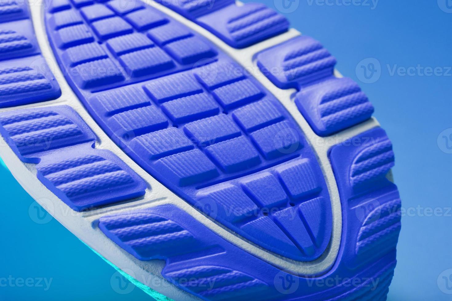 Fragment of the sole of a blue sneaker close-up. Textured texture of the material of sports shoes. photo
