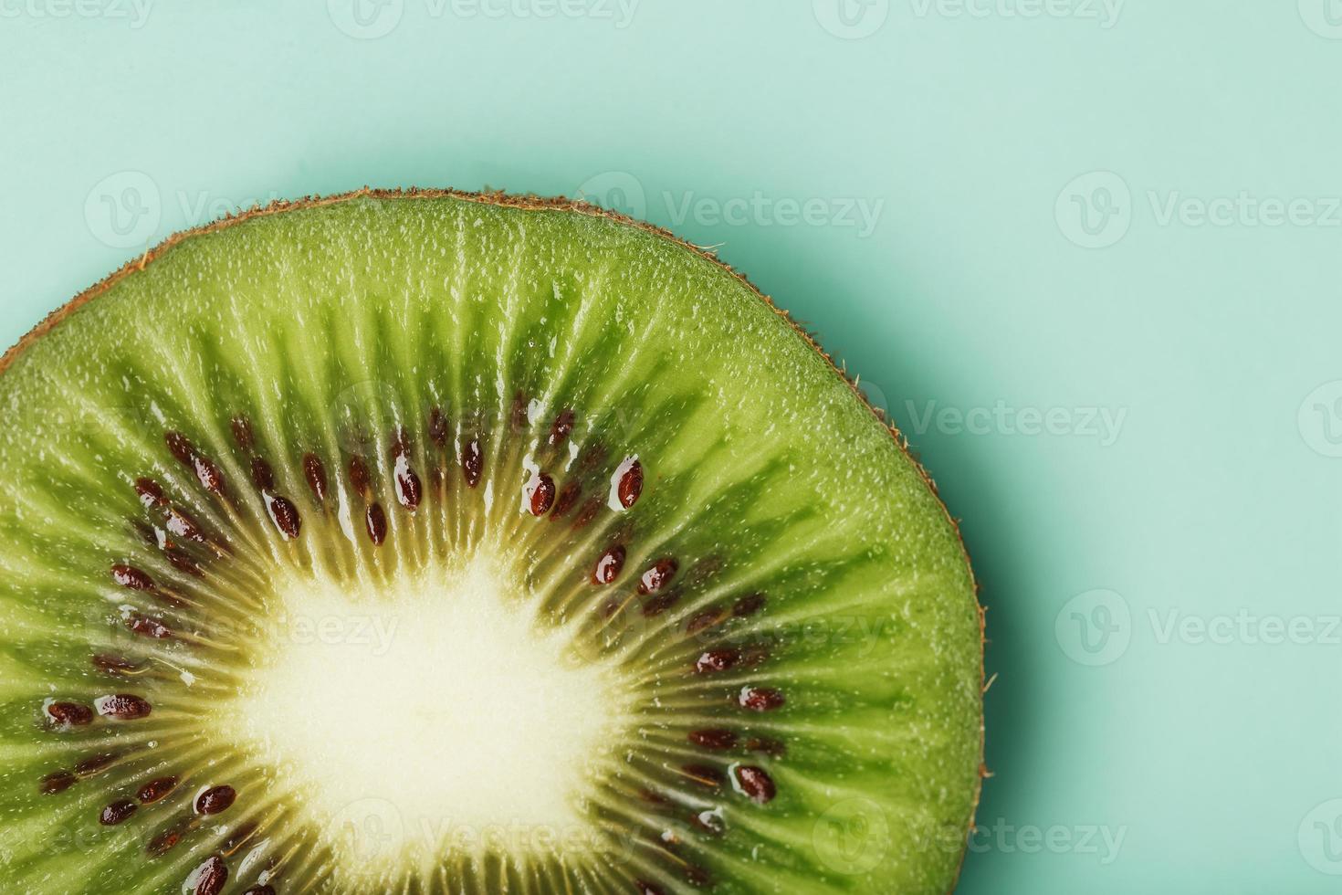 Kiwi slice close-up in full screen, as a background. photo