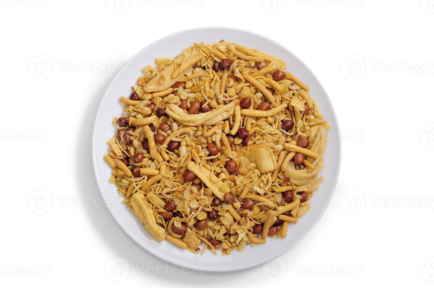 Bombay mix chanachur and nut on white ceramic plate top view photo