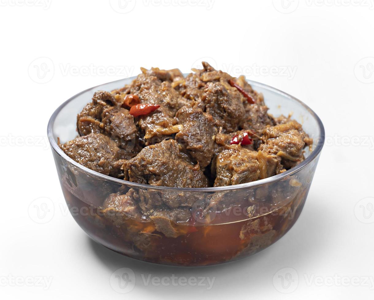 Traditional Beef Curry Served in transparent bowl front view on white Background photo
