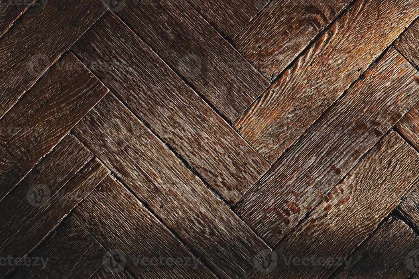 The texture of the old wooden floor, the diagonal arrangement of the parquet Board. photo