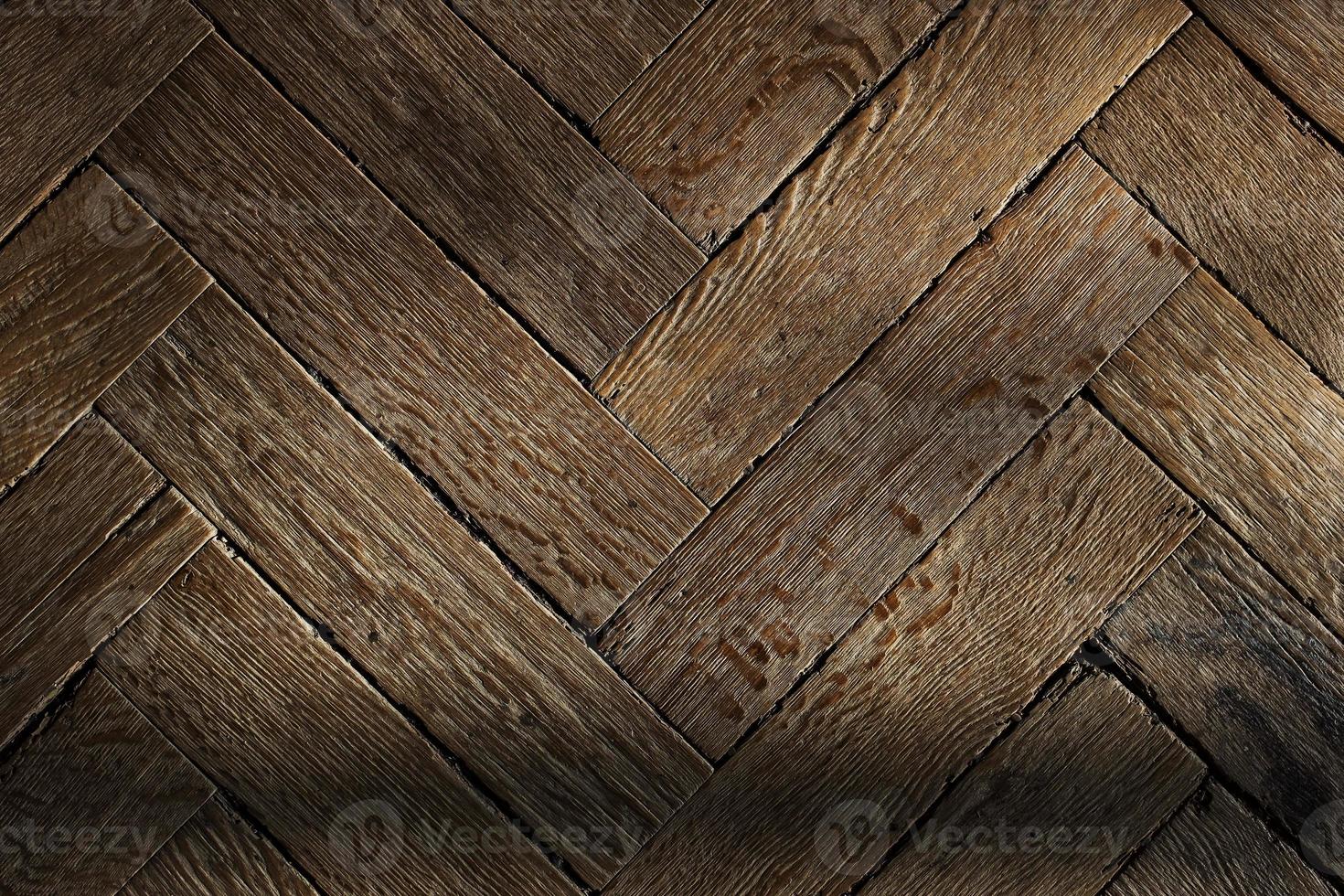 The texture of the old wooden floor, the diagonal arrangement of the parquet Board. photo