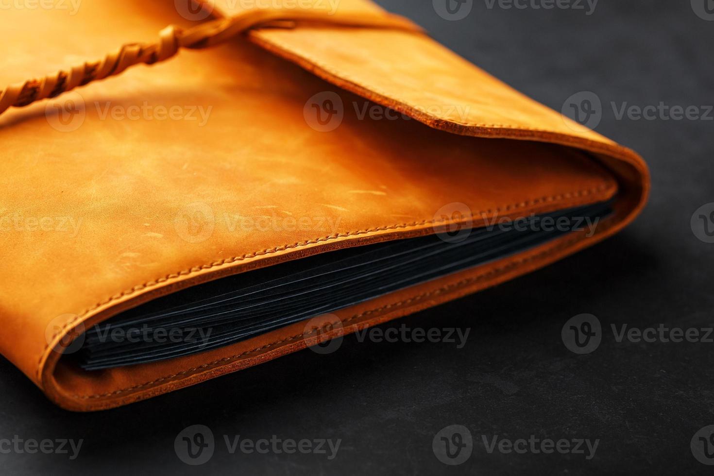 Photo album with blank black for photos. Split rings for close-up macro albums.The album cover is made of brown handmade genuine leather on a black background.