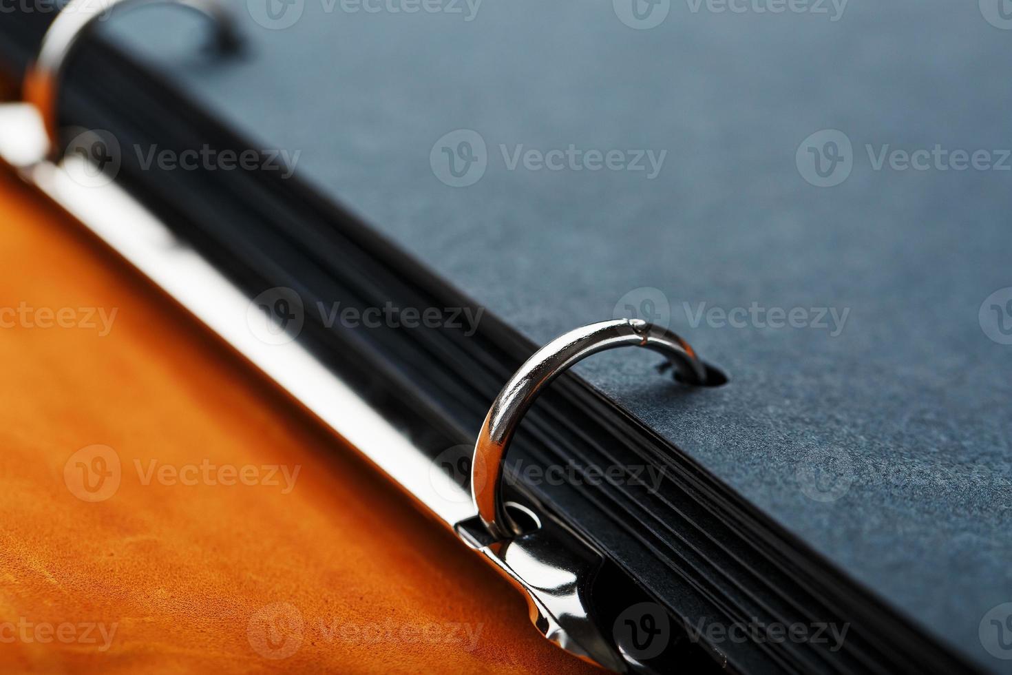 Photo album with blank black for photos. Split rings for close-up macro albums.The album cover is made of brown handmade genuine leather on a black background.