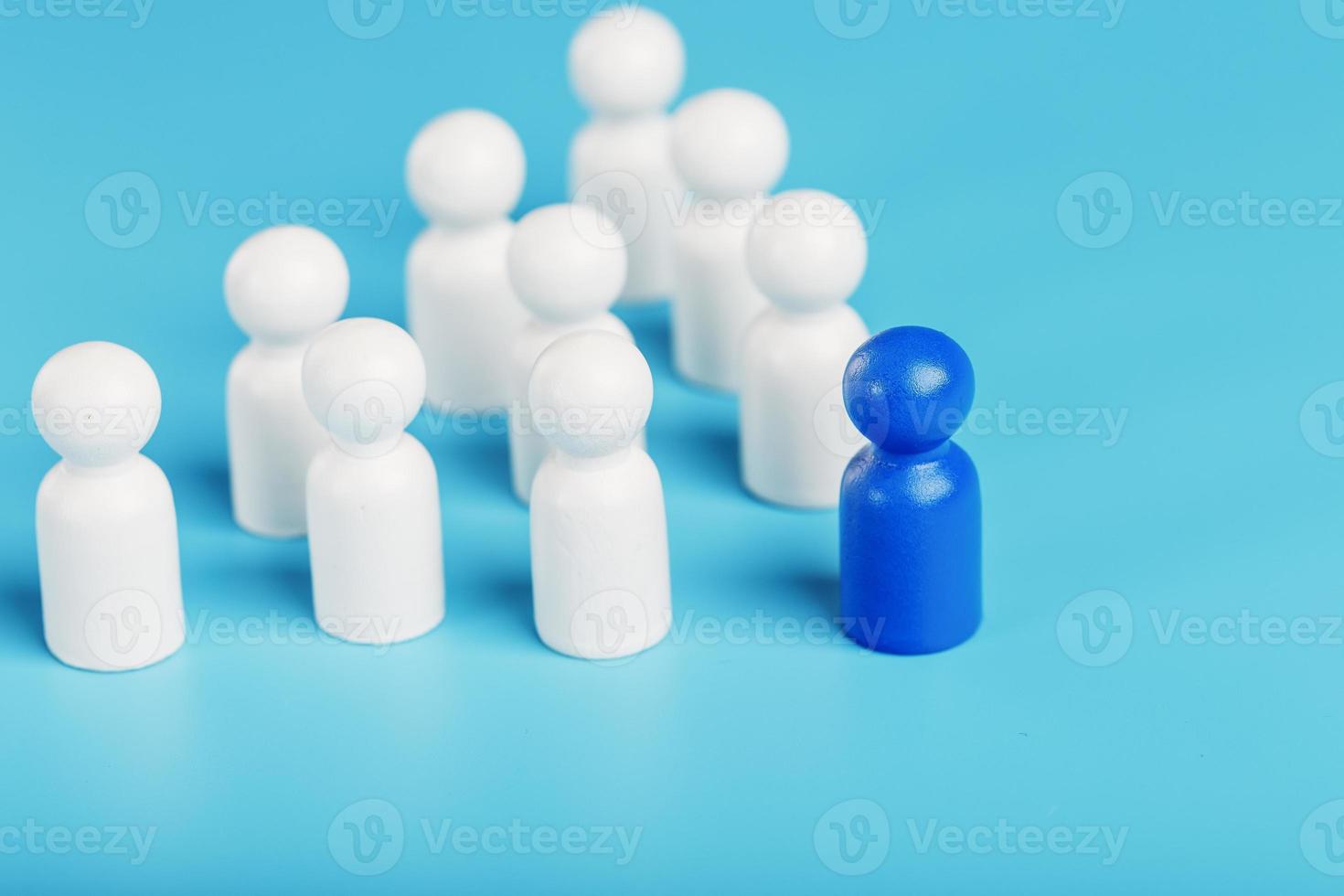 The leader in blue leads a group of white employees to victory, HR, Staff recruitment. The concept of leadership. photo