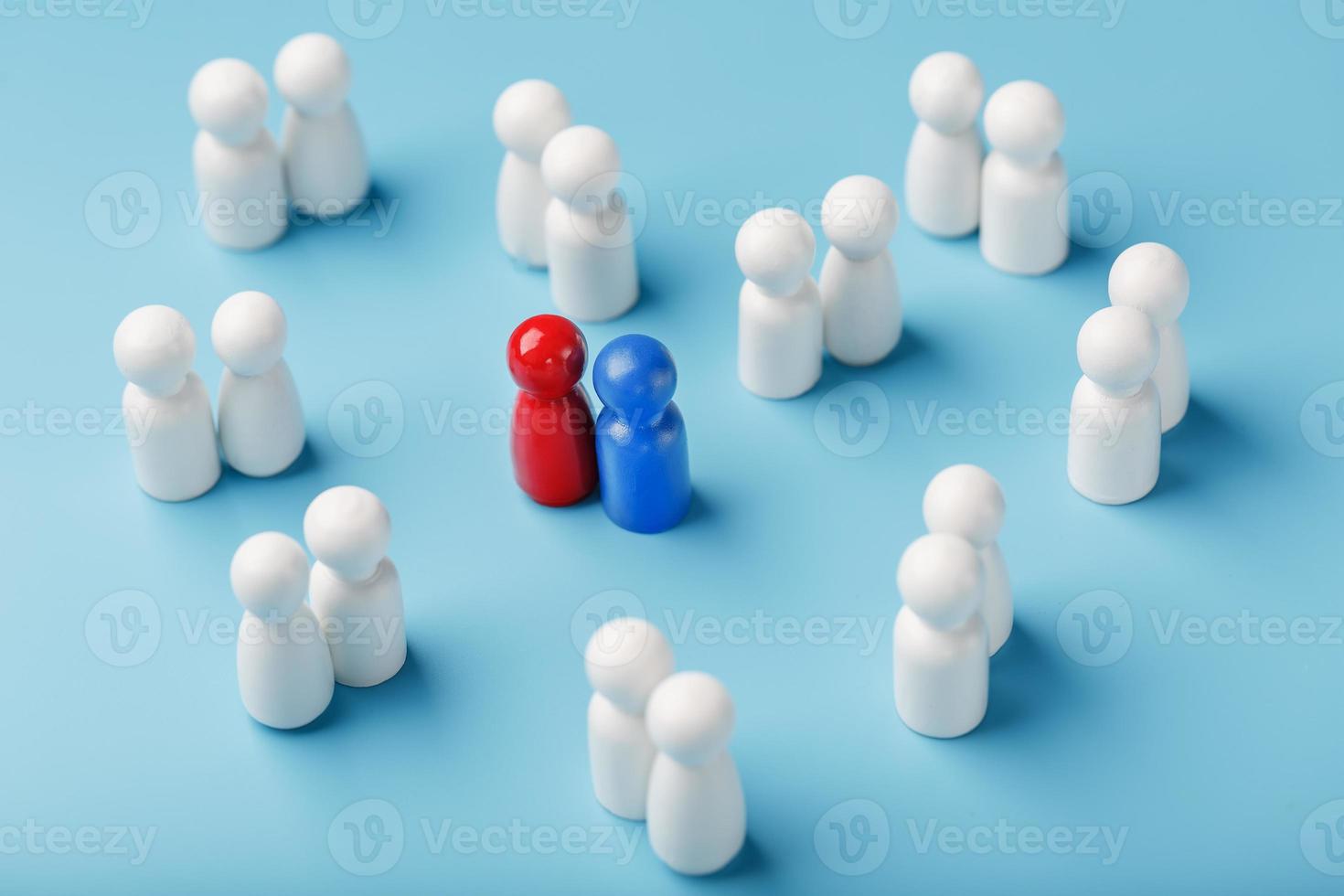 Choosing a sexual partner for love, relationships from such a crowd of monotonous people. A red woman and a blue man in a crowd of white people. photo