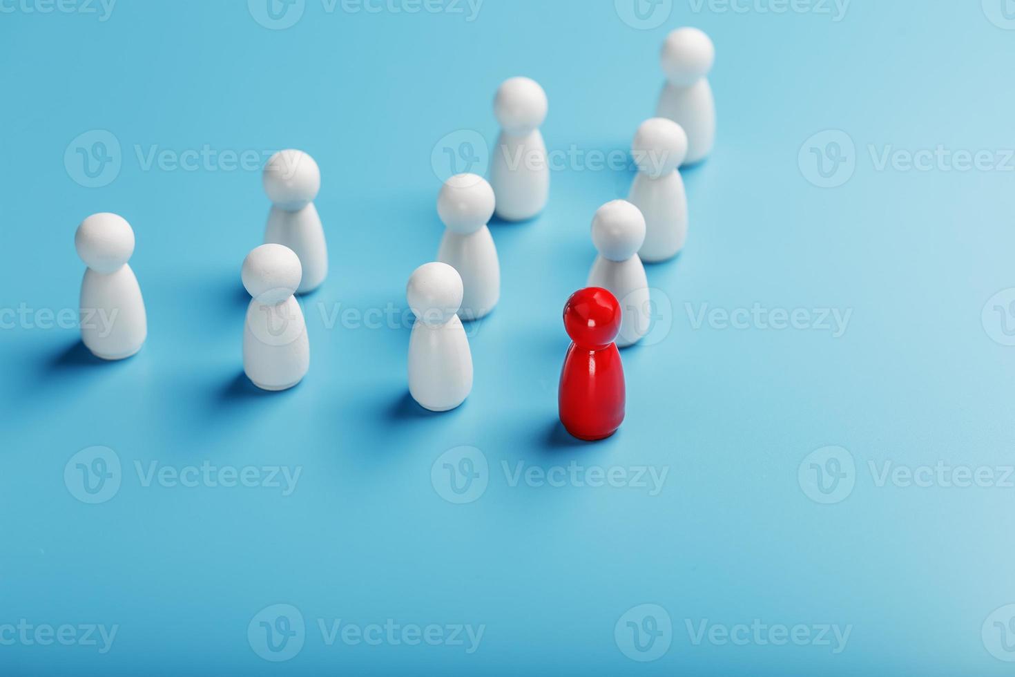 The leader in red leads a group of white employees to victory, HR, Staff recruitment. The concept of leadership. photo