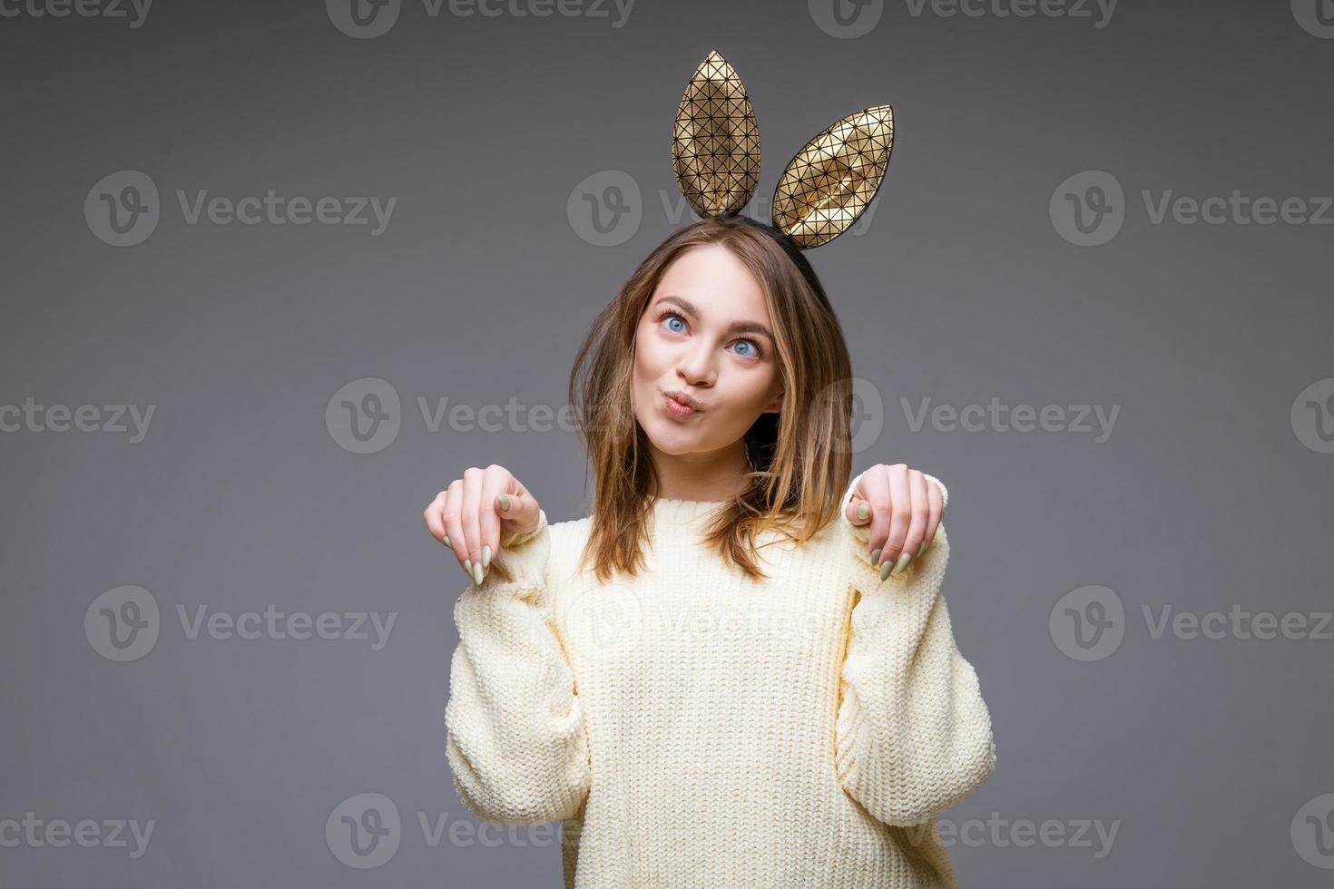 beautiful young woman with ears posing on background photo