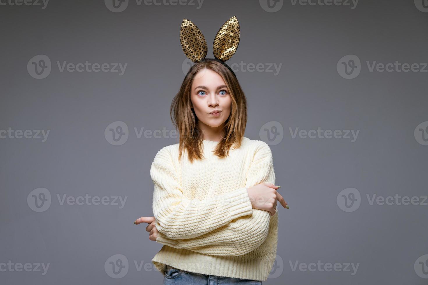 beautiful young woman with ears posing on background photo