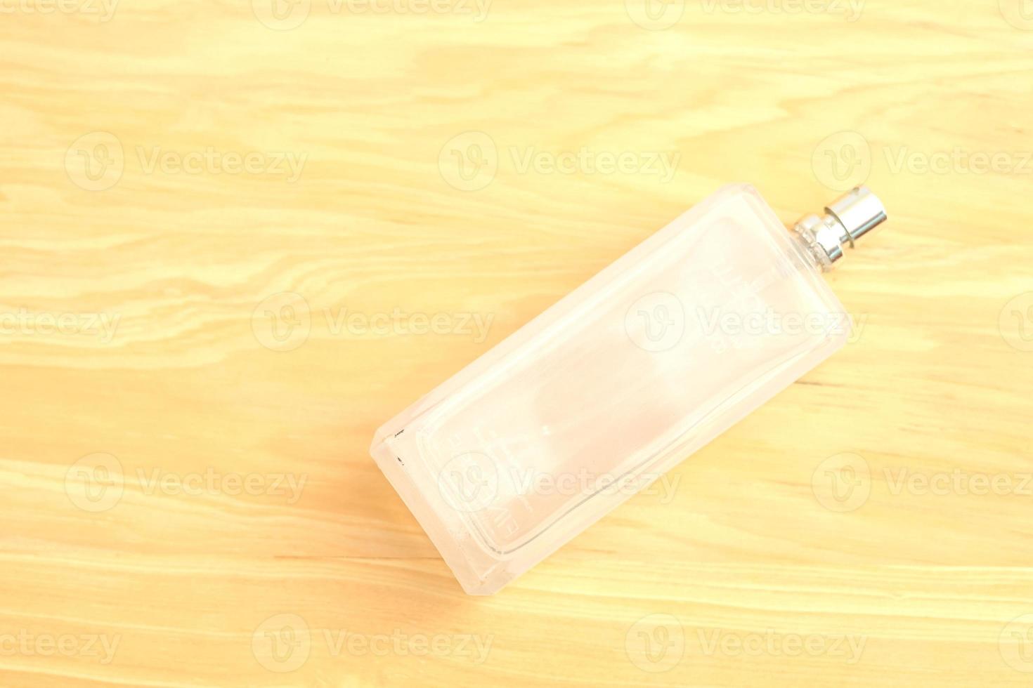 Plain oil bottle on a wooden background photo